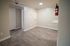 Modern apartment interior with sleek wood flooring and neutral wall colors, offering a stylish and versatile living space.
