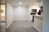 Chic apartment interior featuring sleek wood flooring, modern open-plan kitchen, and bright, spacious area.