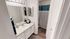 Elegant bathroom with modern fixtures, large mirror, and stylish decor featuring vibrant blue and white accents.