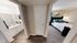 Inviting apartment interior featuring a cozy bedroom with elegant decor and an adjacent modern bathroom, showcasing a warm and comfortable living space.