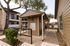Charming apartment complex with a convenient mail center shaded by lush trees, perfect for community living.