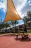Inviting outdoor area with modern shade structure and picnic table, ideal for relaxation and social gatherings.