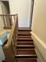 Inviting staircase with elegant wooden steps and stylish railing, leading to upper-level living spaces.