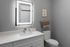 Contemporary bathroom featuring a sleek illuminated mirror, modern fixtures, and stylish decor.