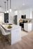 Sleek modern kitchen with white cabinetry, stainless steel appliances, and a stylish marble island with elegant lighting fixtures.