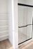 Bright modern bathroom with sleek glass shower and built-in shelving, offering a clean and elegant design.