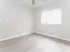 Bright, spacious bedroom with elegant wood flooring, modern ceiling fan, and ample closet space.