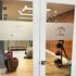 Inviting cardio clinic entrance with glass doors, showcasing bright and modern fitness equipment inside.
