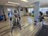 Bright and modern fitness center with state-of-the-art cardio equipment, vibrant exercise balls, and sleek laminate flooring, perfect for a healthy lifestyle.