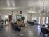 Modern open-concept lounge area with contemporary lighting, sleek furniture, and an inviting atmosphere.