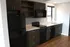 Modern kitchen with new appliances and wooden cabinets