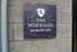 Stone sign with "the Norwood" and address with logo