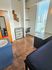 Contemporary apartment room with sleek furnishings, accent wall art, and abundant natural light through large windows.