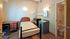 Cozy bedroom with modern furniture, private ensuite bathroom, and ample natural light.