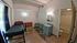 Cozy apartment room with modern furniture, large window, and private bathroom access.