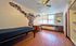 Bright, modern bedroom with unique mural wall art, stylish desk, and ample natural light from large windows.