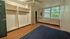 Inviting bedroom with large windows, ample closet space, and serene views of lush greenery.