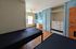 Bright and inviting bedroom with dual beds, ample built-in storage, a cozy study desk, and large window for natural light.