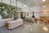Modern open-concept living space with stylish seating, lush green wall, and contemporary fireplace, perfect for relaxation and social gatherings.