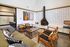 Chic living room with modern furniture, a stylish fireplace, and vibrant decor creating a cozy atmosphere.