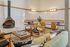 Chic living area featuring a modern fireplace, stylish seating, and a vibrant, eclectic decor for a cozy, inviting ambiance.
