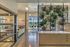 Beautifully designed open-plan living space with natural light, modern decor, and indoor greenery wall for a serene atmosphere.