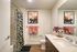 Contemporary bathroom featuring elegant floral shower curtain, chic artwork, and vibrant decor enhancing a serene atmosphere.