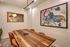 Chic and modern meeting room with stylish wall art and elegant wooden table, ideal for creative brainstorming sessions.