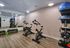 Modern fitness room with sleek exercise bikes, mirrored wall, and well-organized workout equipment for a convenient home gym experience.