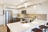 Modern kitchen with sleek stainless steel appliances, elegant white cabinetry, and a spacious island perfect for entertaining.