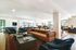 Modern communal lounge with plush leather sofas, sleek chairs, and a vibrant interior design, offering a trendy entertainment space.