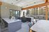 Modern outdoor kitchen with sleek countertops, a built-in grill, and stylish bar seating, perfect for entertaining.
