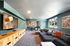 Modern apartment lounge with chic decor, plush seating, and large windows filling the space with natural light.