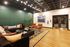 Chic luxury apartment lounge with stylish seating, colorful art, and vibrant area rug, ideal for sophisticated relaxation.