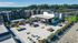 Spacious rooftop terrace featuring stylish seating areas, entertainment spaces, and lush greenery with stunning views of surrounding greenery and modern architecture.