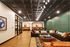 Luxurious communal lounge with modern seating, vibrant decor, and elegant ceiling lights.