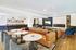 Elegant modern lounge with luxurious leather seating, stylish decor, and a vibrant entertainment area.