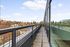 Expansive outdoor balcony with panoramic city views and ample space for relaxation and entertainment.