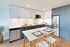 Modern kitchen featuring sleek cabinetry, stainless steel appliances, and a stylish dining area with chic decor.