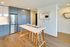 Bright modern kitchen with sleek cabinetry, stainless steel appliances, and a stylish dining area perfect for entertaining.