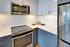 Modern kitchen with sleek stainless steel appliances, elegant white cabinetry, and a polished countertop for style and functionality.