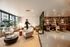 Chic apartment lounge with stylish seating, modern decor, and ambient lighting offering a cozy, contemporary vibe.