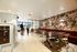 Chic communal space with vibrant floral wallpaper, stylish seating, and modern lighting, offering a welcoming and trendy atmosphere.