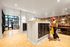 Modern apartment lobby with stylish mail area and vibrant floral wallpaper, featuring sleek lighting and chic decor.