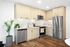 Contemporary kitchen with sleek stainless steel appliances, elegant wood cabinetry, and stylish indoor plants.
