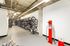 Modern apartment bike storage area with neatly organized bicycle racks and repair station, showcasing convenience and urban living.