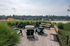 Charming rooftop patio with cozy seating and lush greenery, offering stunning cityscape views.