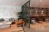 Chic communal space featuring a stylish seating area with modern decor, vibrant botanical wallpaper, and elegant wall art accents.