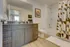 Modern bathroom with elegant wood vanity, chic fixtures, and contemporary geometric shower curtain.