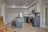 Modern apartment kitchen featuring sleek cabinetry, stainless steel appliances, and a cozy breakfast bar with seating.